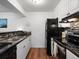 Well-lit kitchen featuring stainless steel appliances, granite countertops, and stylish tile backsplash at 7665 E Eastman Ave # 110, Denver, CO 80231