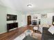 Open-concept living area with neutral walls, hardwood floors, and lots of natural light at 7665 E Eastman Ave # 110, Denver, CO 80231
