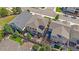 An aerial view shows a home with a landscaped backyard, patio, mature trees, and a privacy fence at 1901 Corner Rock Ln, Castle Rock, CO 80108