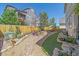 Beautiful backyard featuring a rock garden, artificial turf, landscaped flower beds, and a patio with dining set at 1901 Corner Rock Ln, Castle Rock, CO 80108