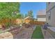 Well-maintained backyard with a stone patio, artificial turf, decorative rock feature, and lovely landscaping at 1901 Corner Rock Ln, Castle Rock, CO 80108