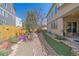 Lush backyard with rock garden, artificial turf, mature landscaping, and a cozy patio area for outdoor enjoyment at 1901 Corner Rock Ln, Castle Rock, CO 80108