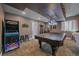 Finished basement featuring a pool table with a unique light fixture and a classic arcade game at 1901 Corner Rock Ln, Castle Rock, CO 80108