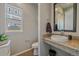 Stylish powder room features a granite vanity, vessel sink, and modern fixtures at 1901 Corner Rock Ln, Castle Rock, CO 80108