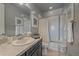 Neutral bathroom with a dark vanity, and a shower/tub combo with a white shower curtain at 1901 Corner Rock Ln, Castle Rock, CO 80108