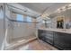 Luxurious bathroom features glass shower enclosure, dual vanities, and designer fixtures at 1901 Corner Rock Ln, Castle Rock, CO 80108