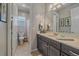 Bright bathroom featuring a vanity with a large mirror, and a toilet with a shower/bath combo at 1901 Corner Rock Ln, Castle Rock, CO 80108