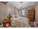 Cozy bedroom featuring neutral paint, a decorative star, ample natural light, and a stylish dresser at 1901 Corner Rock Ln, Castle Rock, CO 80108