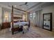 Spacious main bedroom boasts a four-poster bed, ceiling fan, and designer decor at 1901 Corner Rock Ln, Castle Rock, CO 80108