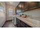 Functional laundry room with modern appliances, ample countertop space, and dark cabinetry at 1901 Corner Rock Ln, Castle Rock, CO 80108