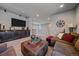 Spacious living room featuring sectional sofa, ottoman, and entertainment center at 1901 Corner Rock Ln, Castle Rock, CO 80108