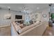Bright living room features a large sectional sofa, media center, ceiling fan, and sun-filled windows at 1901 Corner Rock Ln, Castle Rock, CO 80108