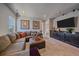 Spacious living room with sectional, ottoman, entertainment center and plush carpeting at 1901 Corner Rock Ln, Castle Rock, CO 80108