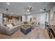 Bright, open-concept living room features a large sectional, stylish decor and adjoins the gourmet kitchen at 1901 Corner Rock Ln, Castle Rock, CO 80108