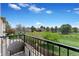 Scenic balcony view showcasing a serene green landscape, manicured lawn, and distant homes in the neighborhood at 14058 E Temple Dr, Aurora, CO 80015
