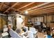 Unfinished basement with exposed ceiling, storage items, and potential for customization and expansion at 14058 E Temple Dr, Aurora, CO 80015