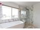 Contemporary bathroom featuring a soaking tub, a window view, and a frameless glass shower at 14058 E Temple Dr, Aurora, CO 80015