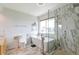 Modern bathroom with a large soaking tub, a glass enclosed shower, and marble accents at 14058 E Temple Dr, Aurora, CO 80015