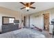 Bedroom featuring a ceiling fan, multiple closets, and an ensuite bathroom at 14058 E Temple Dr, Aurora, CO 80015