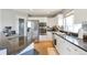 Well-appointed kitchen featuring granite countertops, stainless steel appliances, and sleek white cabinetry at 14058 E Temple Dr, Aurora, CO 80015