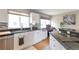 Bright kitchen featuring white cabinets, granite countertops, stainless steel appliances, and a stylish tiled backsplash at 14058 E Temple Dr, Aurora, CO 80015