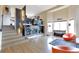 Open living room with fireplace and soaring ceilings, offering abundant natural light and stylish decor at 14058 E Temple Dr, Aurora, CO 80015