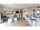 Open-concept area with gray walls, hardwood floors, and a kitchen with bar stool seating and stainless appliances at 14058 E Temple Dr, Aurora, CO 80015