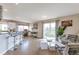 Airy open concept showcasing stylish furniture, and balcony access for seamless indoor-outdoor living at 14058 E Temple Dr, Aurora, CO 80015