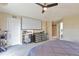 Spacious main bedroom featuring a projector screen, ceiling fan, and ample closet space at 14058 E Temple Dr, Aurora, CO 80015