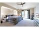 Bright main bedroom featuring a ceiling fan, projector, balcony access, and a neutral color palette at 14058 E Temple Dr, Aurora, CO 80015