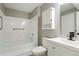 Cozy bathroom features a white vanity, toilet, and shower with updated finishes at 832 S Vance St # F, Lakewood, CO 80226