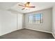 Cozy bedroom featuring carpet, a ceiling fan, and a large window with ample natural light at 832 S Vance St # F, Lakewood, CO 80226