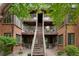 Brick apartment building with trees and stairs leading to the second floor apartments at 832 S Vance St # F, Lakewood, CO 80226