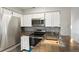 Modern kitchen with stainless steel appliances, white cabinets and sleek countertops at 832 S Vance St # F, Lakewood, CO 80226