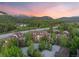 Stunning aerial view of a multi-building residential complex nestled among trees and mountains at sunset at 33 Broken Lance Dr # 207S, Breckenridge, CO 80424