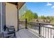 Balcony with chairs overlooking a tree-lined street and other homes in the neighborhood at 33 Broken Lance Dr # 207S, Breckenridge, CO 80424