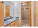 Bathroom features light wood cabinetry, granite countertop, a large mirror, and a shower-tub combination at 33 Broken Lance Dr # 207S, Breckenridge, CO 80424