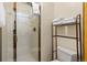 Functional bathroom with a glass-enclosed shower, toilet, and storage shelves, offering a clean and efficient space at 33 Broken Lance Dr # 207S, Breckenridge, CO 80424