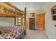 Rustic bedroom featuring a log bunk bed with quilt bedding and wood accents at 33 Broken Lance Dr # 207S, Breckenridge, CO 80424