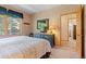 Bedroom featuring a view, vintage wood dresser with TV, and plush bed with decorative pillows at 33 Broken Lance Dr # 207S, Breckenridge, CO 80424