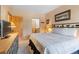 Bedroom with views leading to an ensuite bathroom, plush bed, and vintage wood dresser with TV at 33 Broken Lance Dr # 207S, Breckenridge, CO 80424