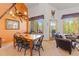 Warm dining area with a rustic chandelier, wooden table and chairs, and ski-themed wall decorations at 33 Broken Lance Dr # 207S, Breckenridge, CO 80424