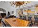 Open dining area with a large wooden table, bar seating, and access to the kitchen and living room at 33 Broken Lance Dr # 207S, Breckenridge, CO 80424