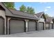 Detached garage units featuring individual numbered doors, offering secure parking and storage for residents at 33 Broken Lance Dr # 207S, Breckenridge, CO 80424