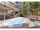 Enjoy the private hot tub with surrounding landscape and building architecture at 33 Broken Lance Dr # 207S, Breckenridge, CO 80424