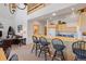 Kitchen with stainless appliances, eat-in bar with seating and a view to the living area at 33 Broken Lance Dr # 207S, Breckenridge, CO 80424