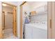 Functional laundry room with washer, dryer, and storage shelves at 33 Broken Lance Dr # 207S, Breckenridge, CO 80424
