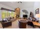 Inviting living room with a stone fireplace, large windows, comfortable seating, and vaulted ceiling at 33 Broken Lance Dr # 207S, Breckenridge, CO 80424