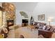 Cozy living room features stone fireplace, comfortable seating, and natural light from large windows at 33 Broken Lance Dr # 207S, Breckenridge, CO 80424