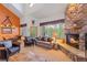 Inviting living room featuring a stone fireplace, comfortable seating, and large windows offering scenic views at 33 Broken Lance Dr # 207S, Breckenridge, CO 80424